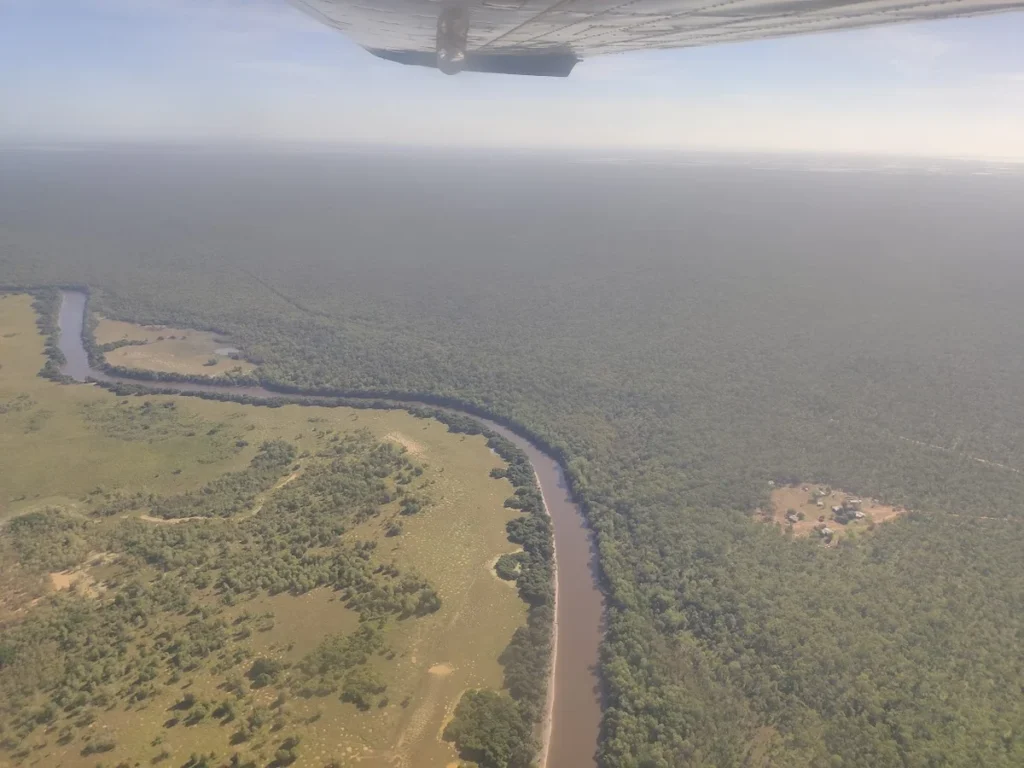 Aerial view of a river winding through the dense wilderness of Arnhem Land in Australia, showing the isolation of remote working locations.