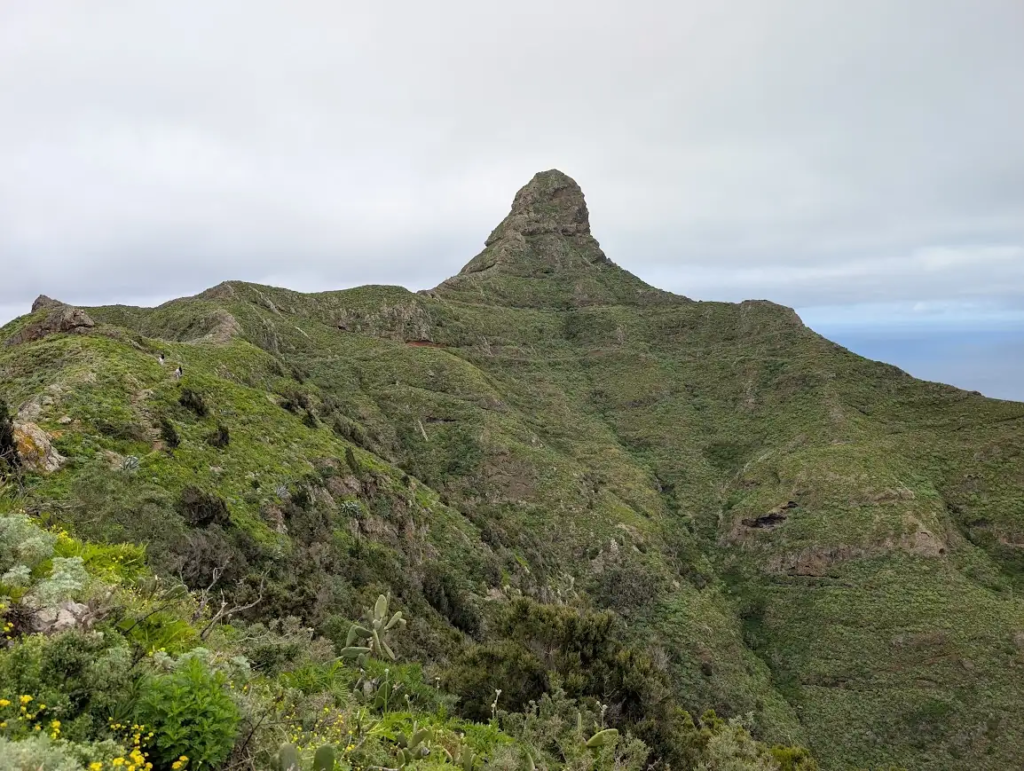 Roque de Taborno rock pinnacle rising above green ridges in Anaga Rural Park, northeast Tenerife