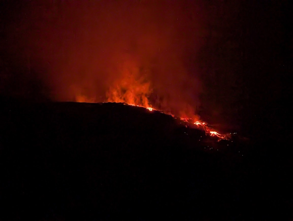 New lava flow glowing red on the slopes of Mount Etna at night, Sicily, February 2025