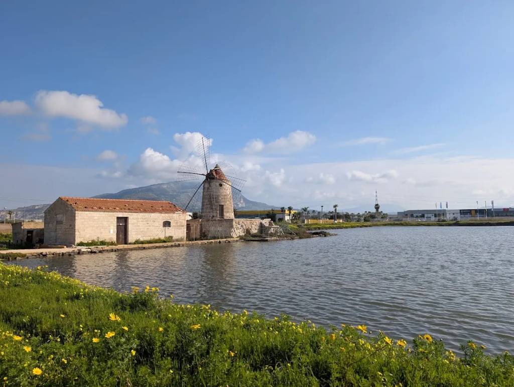 Traditional stone windmill beside the Trapani salt pans wetland nature reserve, northwestern Sicily