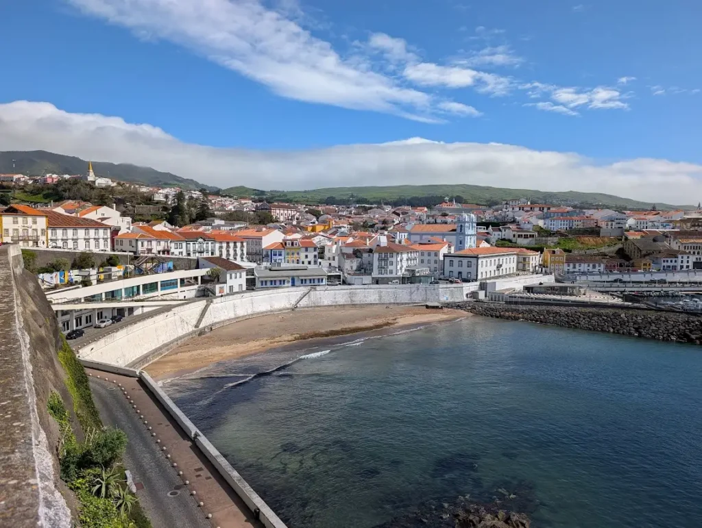 Panoramic view of Angra do Heroísmo from the fortress walls, orange-roofed buildings and small beach by the harbor, Terceira, Azores