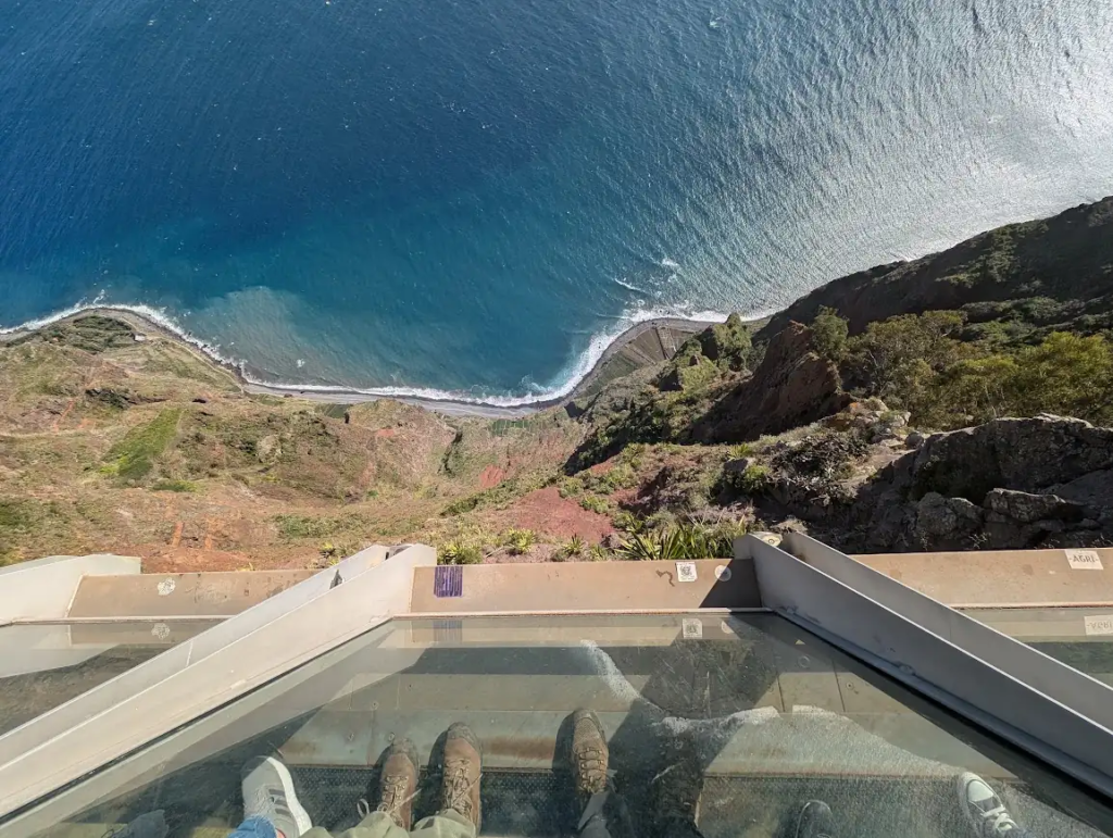 View straight down through the glass floor of the Cabo Girão skywalk to the Atlantic below