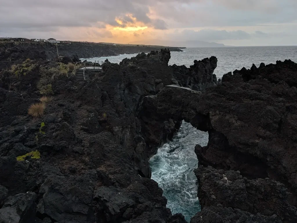 Black lava rock coastline at Cachorro, Pico island, Azores, at sunset