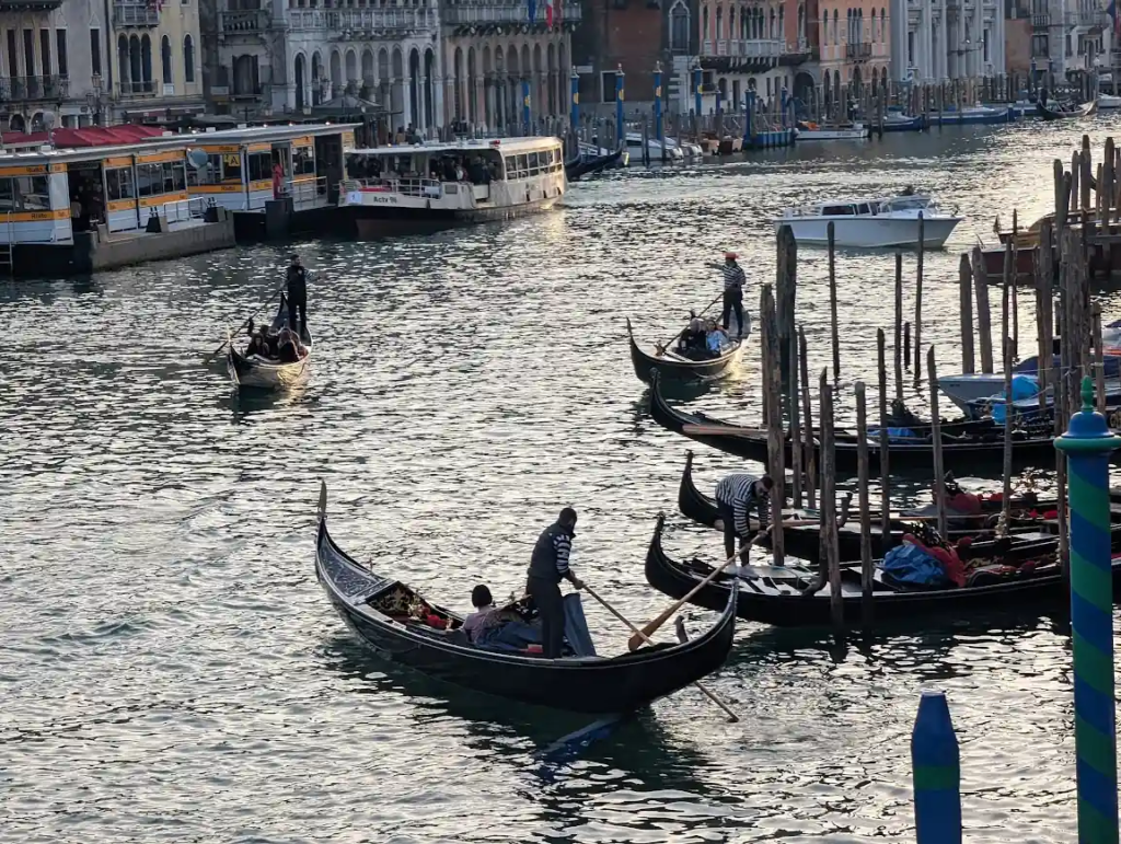 Gondolas and vaporetto on the Grand Canal in Venice at sunset