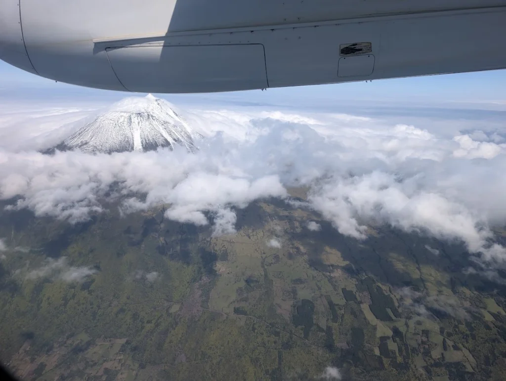 Aerial view of snow-covered Mount Pico volcano from SATA Airlines flight, Azores
