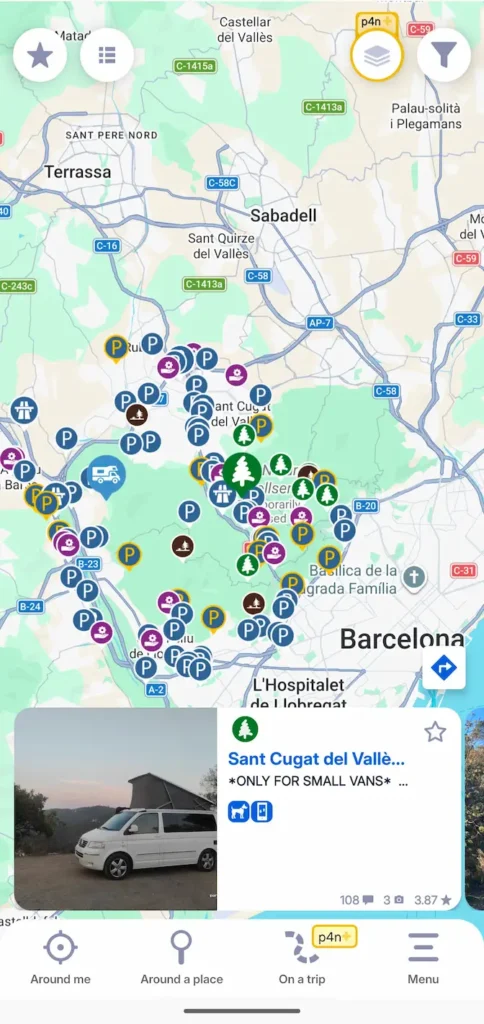 Screenshot of the Park4Night mobile app showing various parking icons and filters on a map of the Barcelona area, with a selected spot detail pane at the bottom.