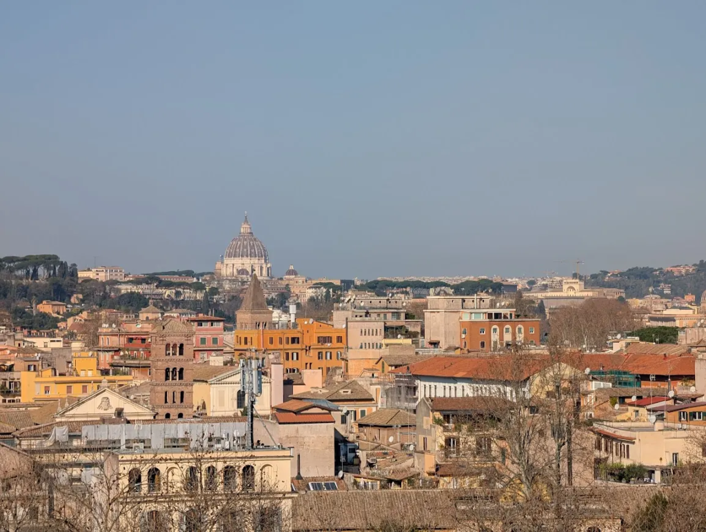 Rome rooftop skyline with St. Peter's Basilica dome visible in the distance, viewed from Janiculum Hill