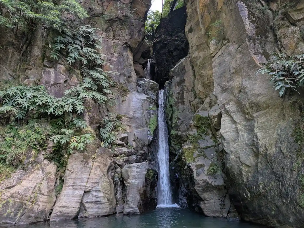 Salto do Cabrito waterfall in narrow rocky gorge, São Miguel, Azores
