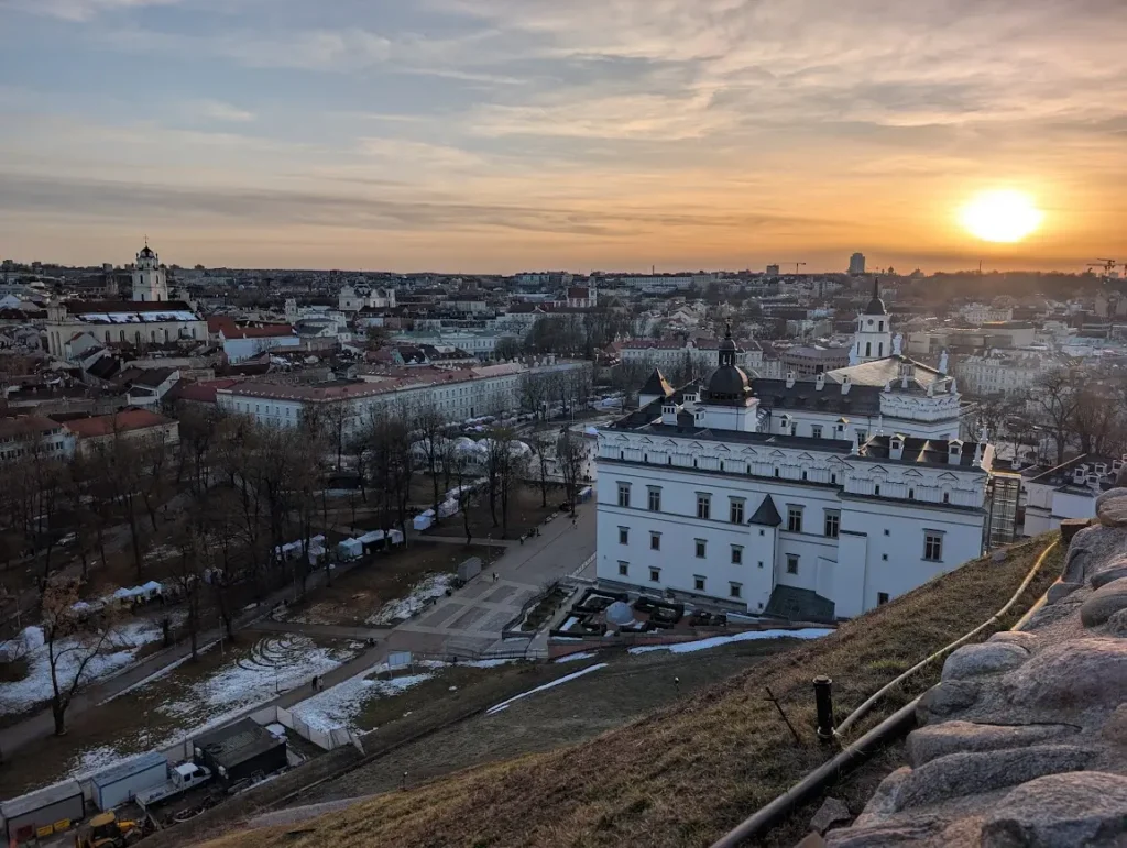 Panoramic view of Vilnius old town at sunset from Gediminas Hill, with the Palace of the Grand Dukes and church spires below, Lithuania