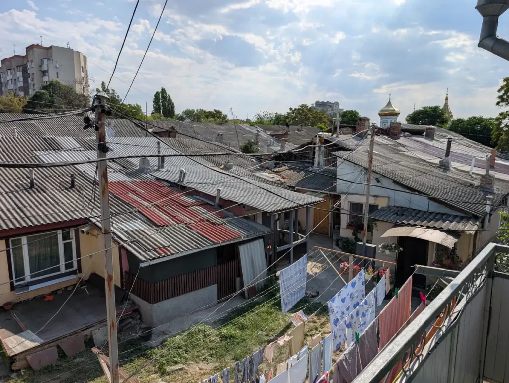 iew from Chisinau hostel balcony showing corrugated rooftops and Orthodox church dome, Moldova