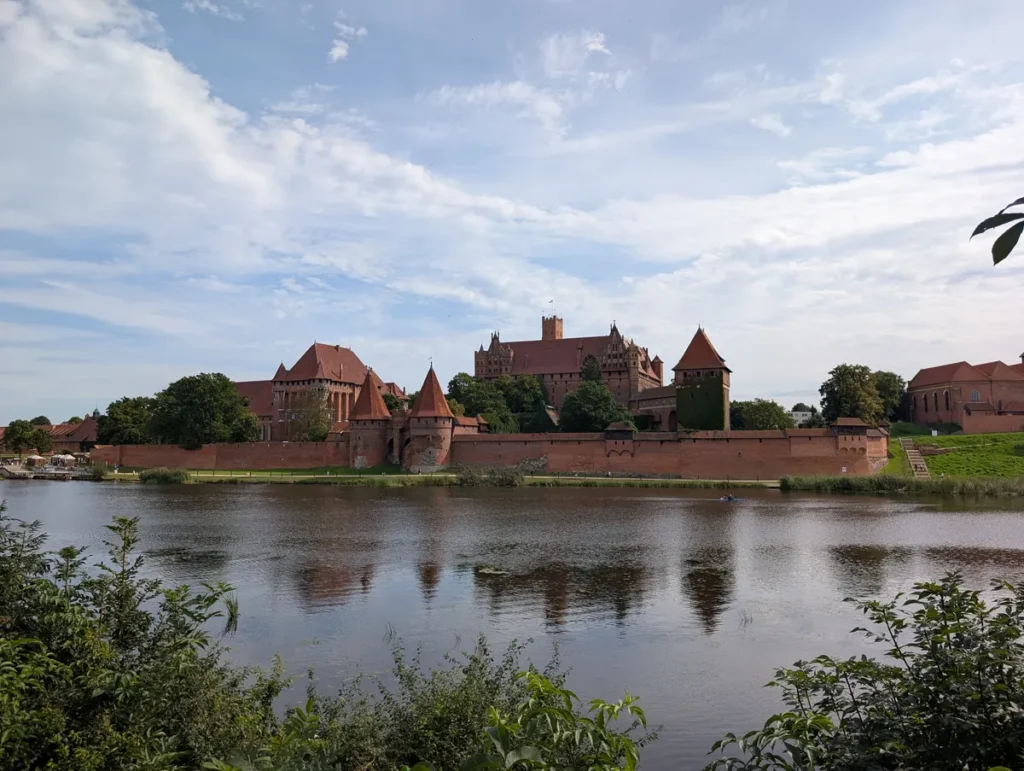 Malbork Castle viewed from across the Nogat river, Poland — largest brick castle in the world by land area