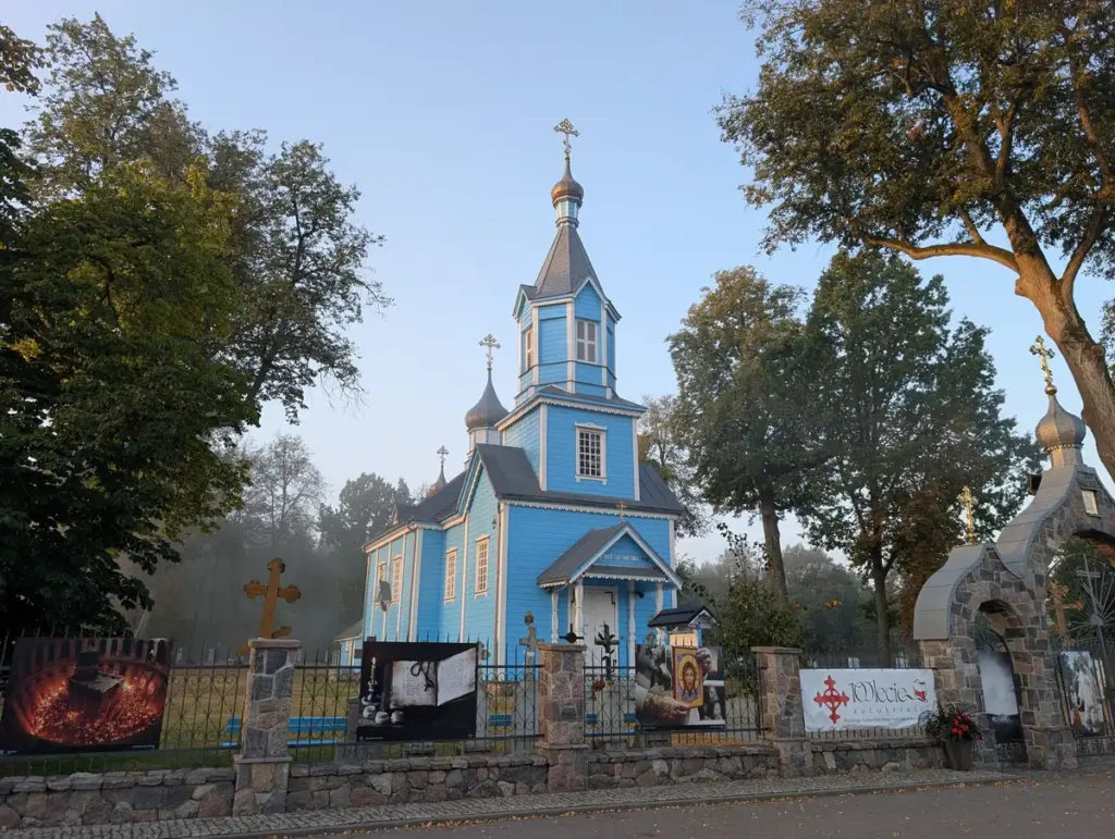 Blue wooden Orthodox church in a Podlasie village, Poland, early morning mist