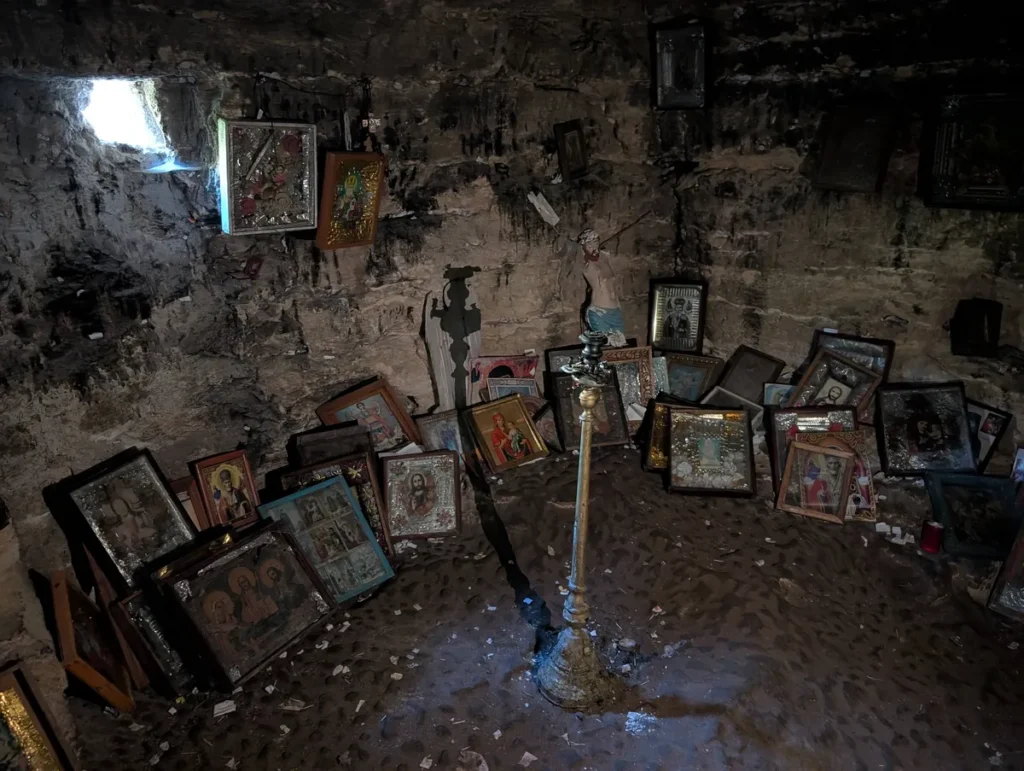 Orthodox icons and candles inside Saharna cave monastery, Moldova