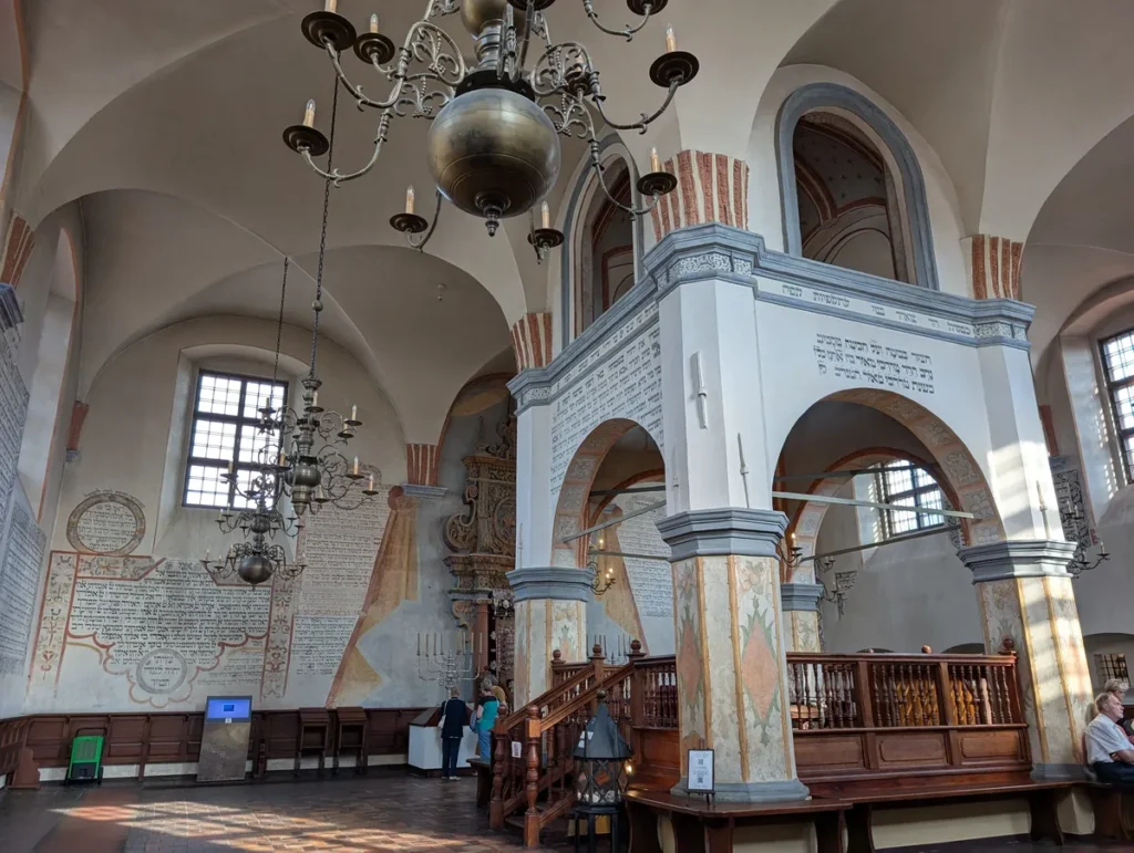 Interior of the 17th-century Tykocin synagogue in Poland, with Hebrew inscriptions on the walls and ornate bimah