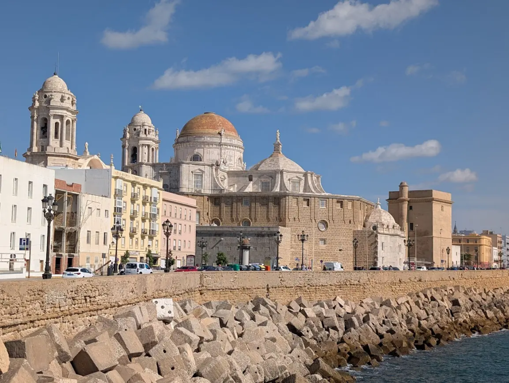 Cádiz Cathedral with golden dome seen from the seafront promenade, Andalusia, Spain