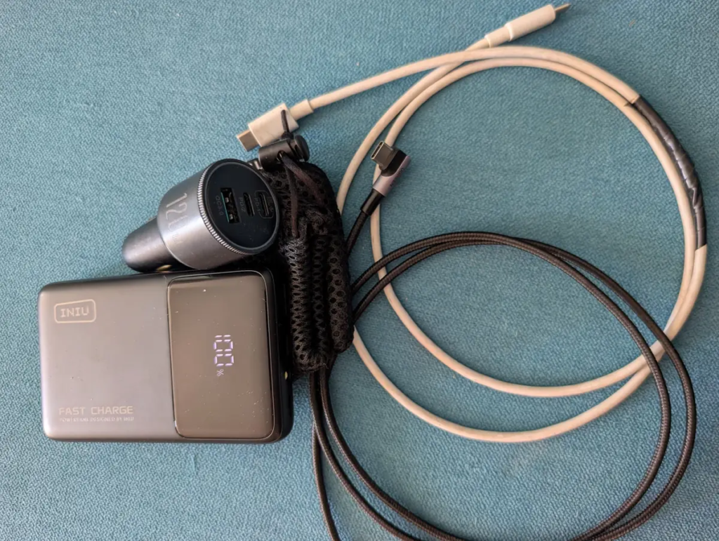 Car charger with three fast-charging ports, a power bank, and two charging cables