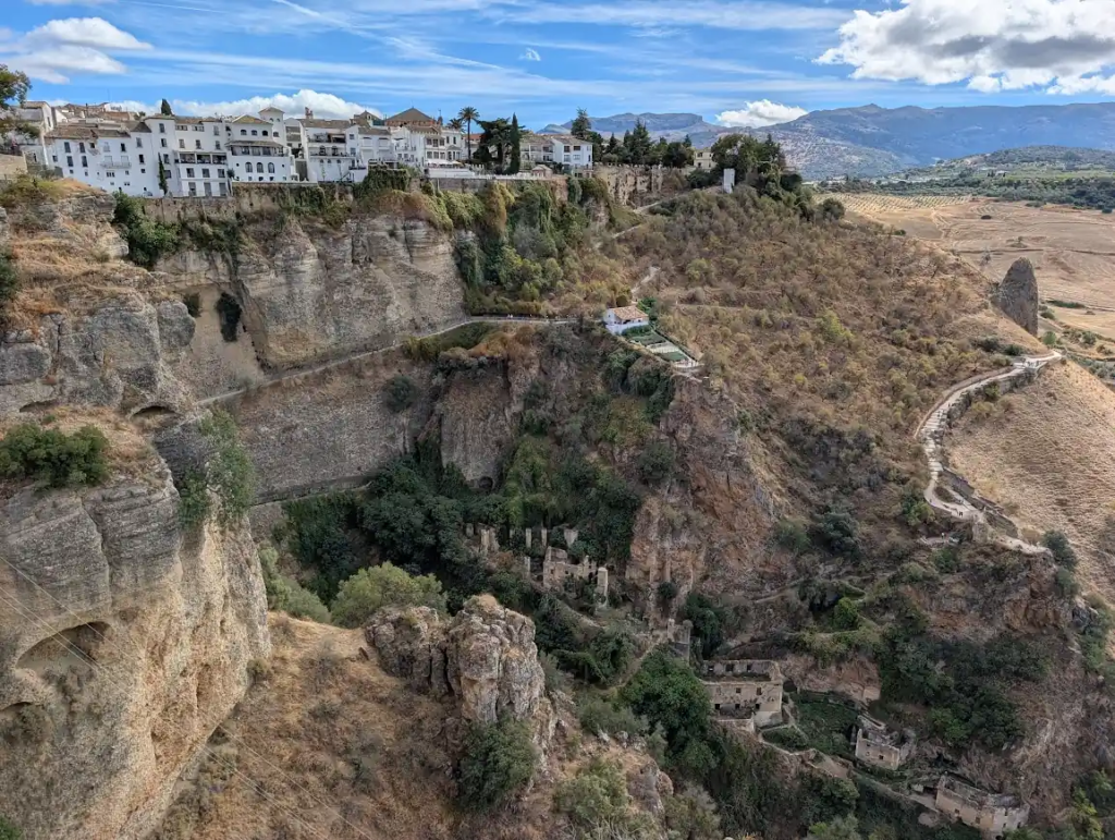 Ronda old town perched on cliffs with the Andalusian landscape beyond
