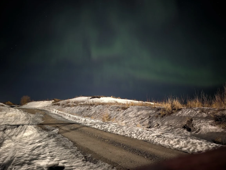 Northern lights over a snowy road near Rovaniemi, Finland, March 2026