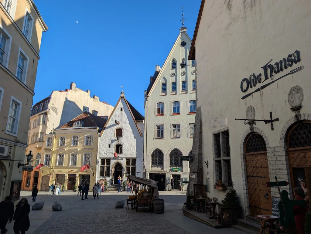 Medieval square in Tallinn old town with Olde Hansa restaurant sign and historic buildings