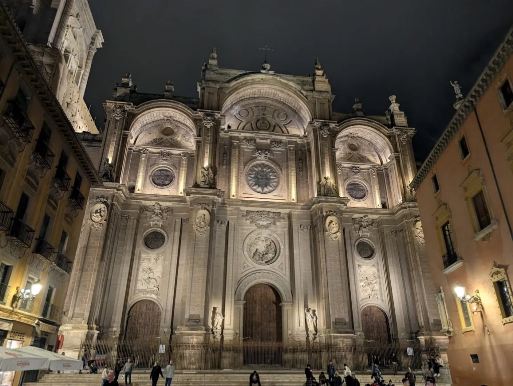 Baroque facade of Catedral de Granada illuminated at night