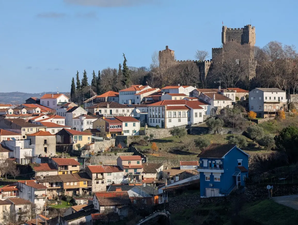 Medieval castle tower on a hill above the terracotta-roofed houses of Bragança, Portugal