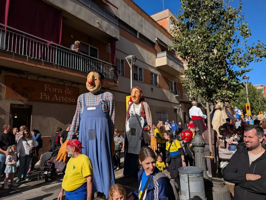Gegants, giant papier-mâché figures in traditional dress, in a street parade at a local festival in Catalonia