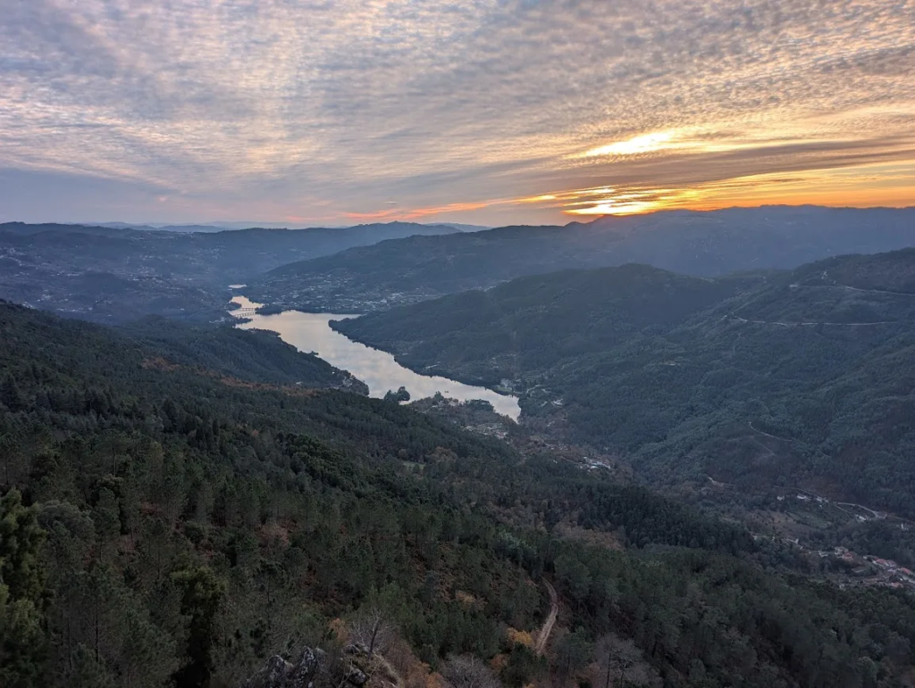 Reservoir winding through forested mountains in Peneda-Gerês National Park, Portugal at sunset