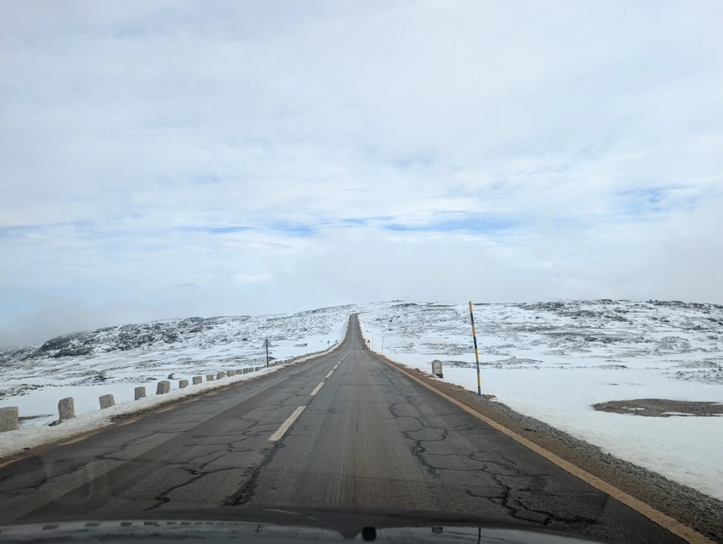 Empty road running through a snow-covered plateau in Serra da Estrela, Portugal, in December
