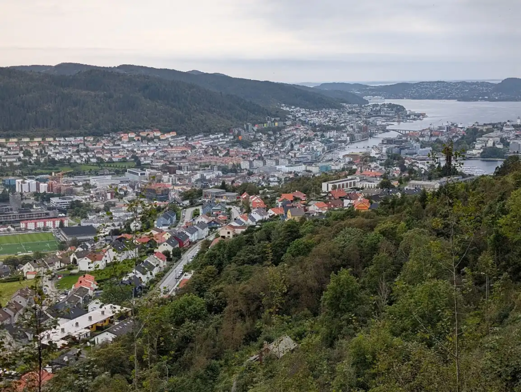 View over Bergen's houses, harbor, and surrounding hills from the slopes of Ulriken on an overcast day